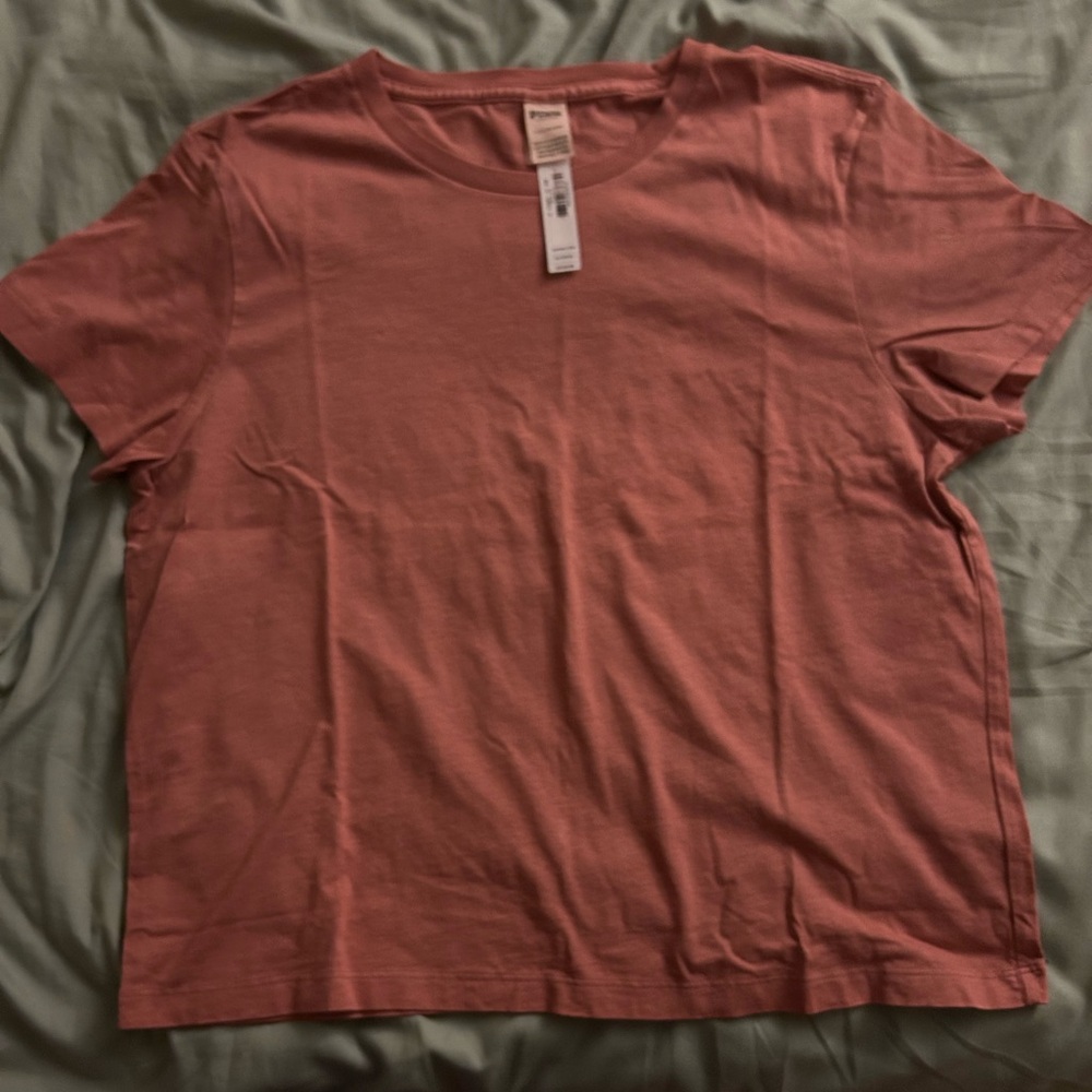 Pink Large tshirt with tags. Never worn.